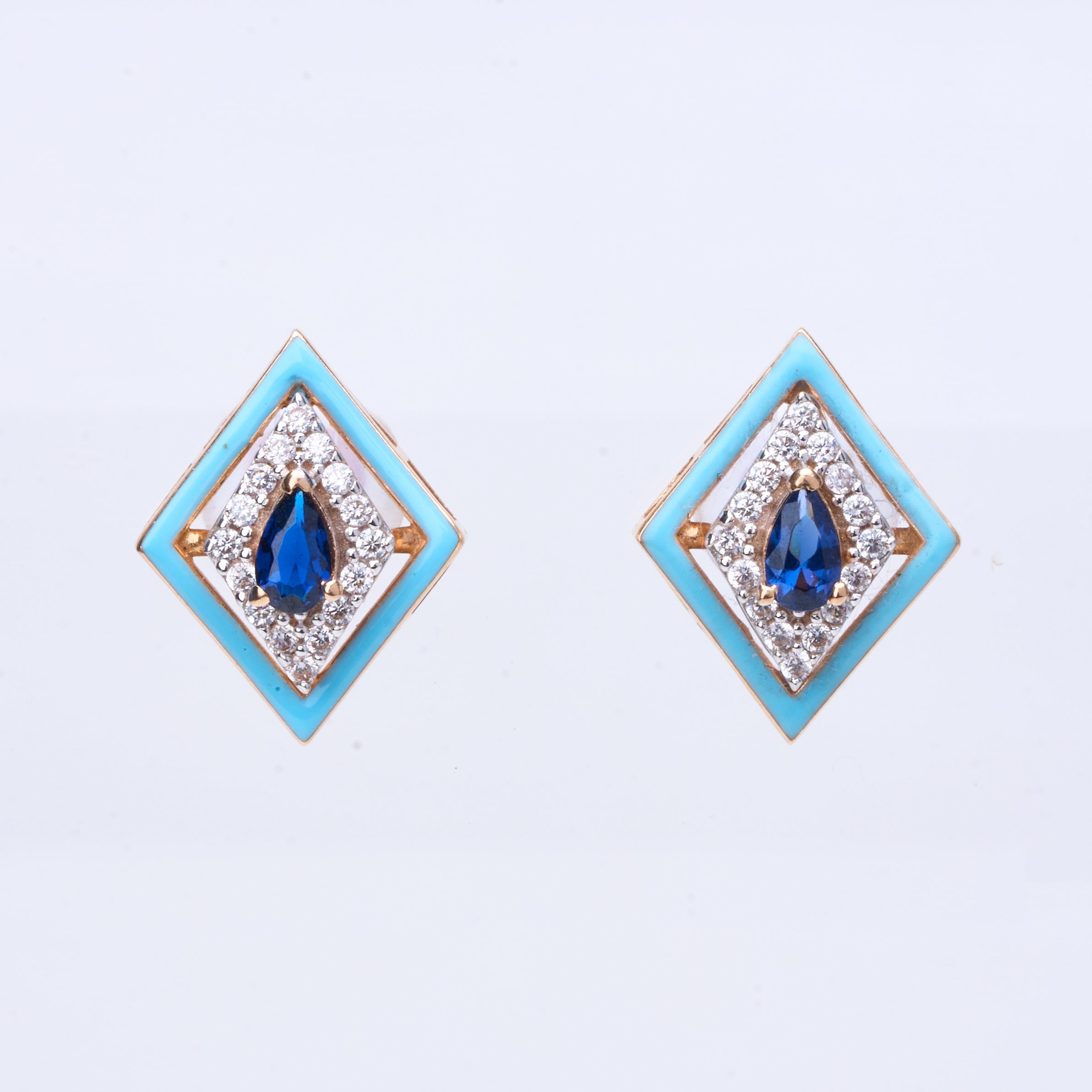 18K gold geometric stud earrings with blue sapphire center and white enamel frame