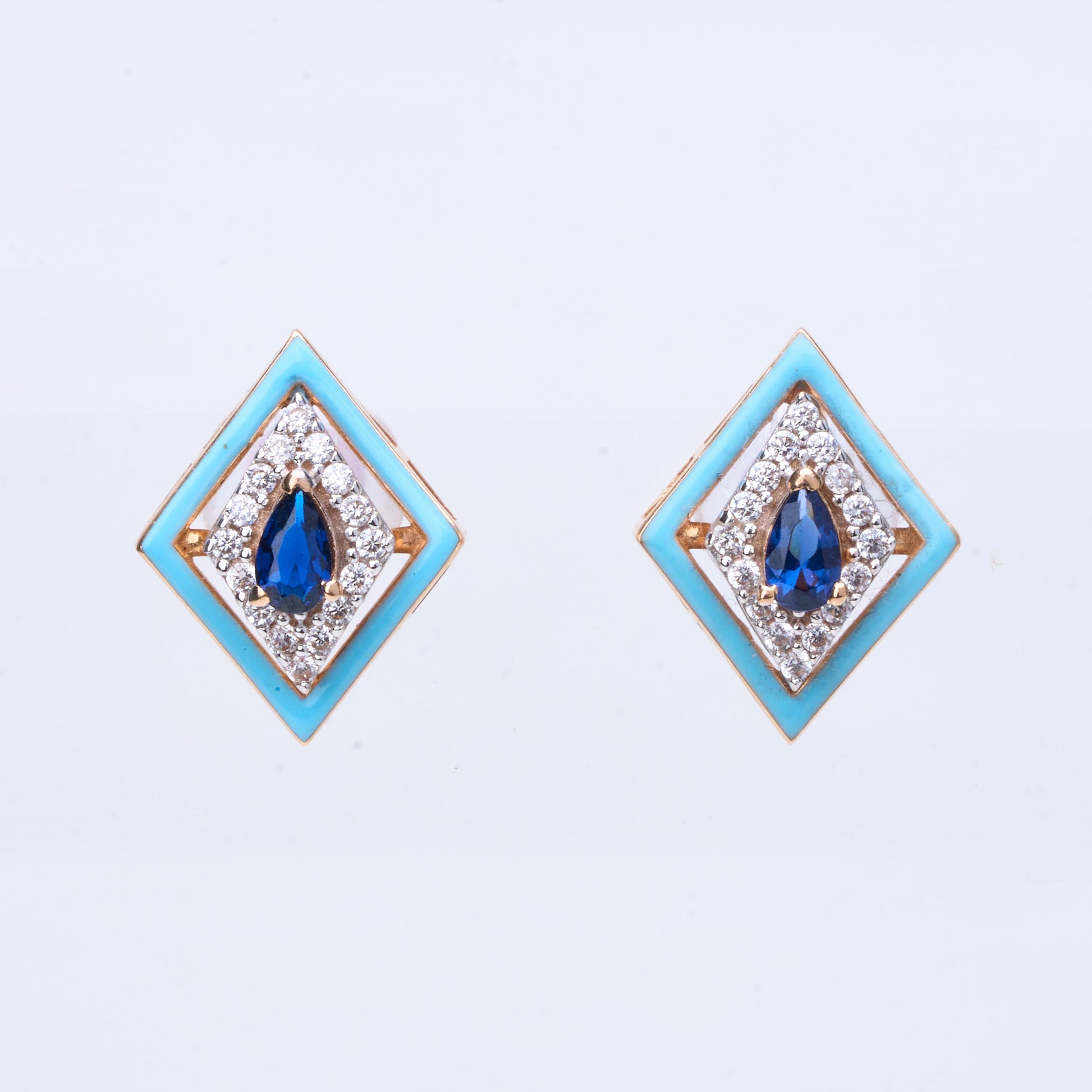 18K gold geometric stud earrings with blue sapphire center and white enamel frame