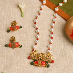 Traditional Kamdhenu temple jewelry set with pearls, coral, and emerald in gold