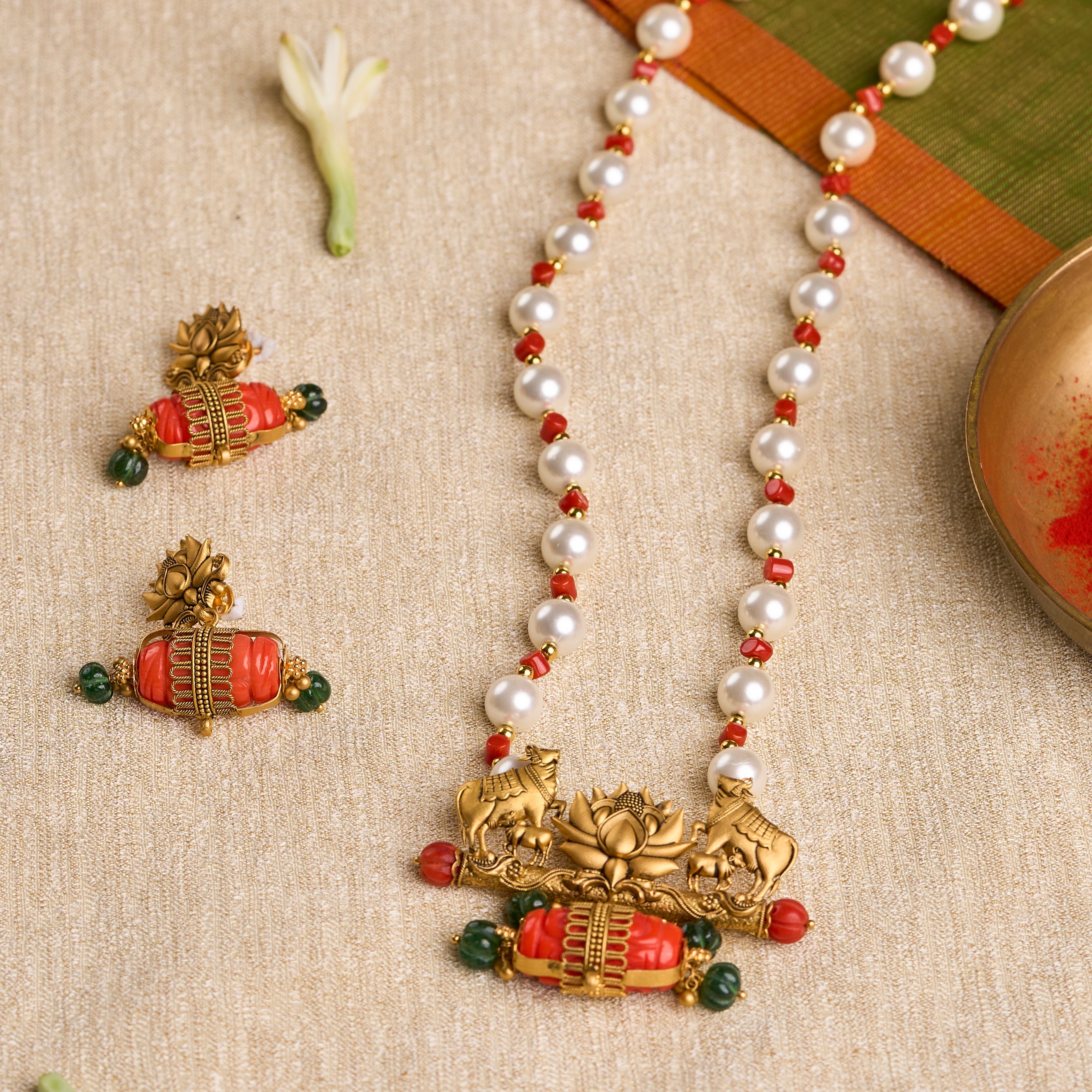 Traditional Kamdhenu temple jewelry set with pearls, coral, and emerald in gold