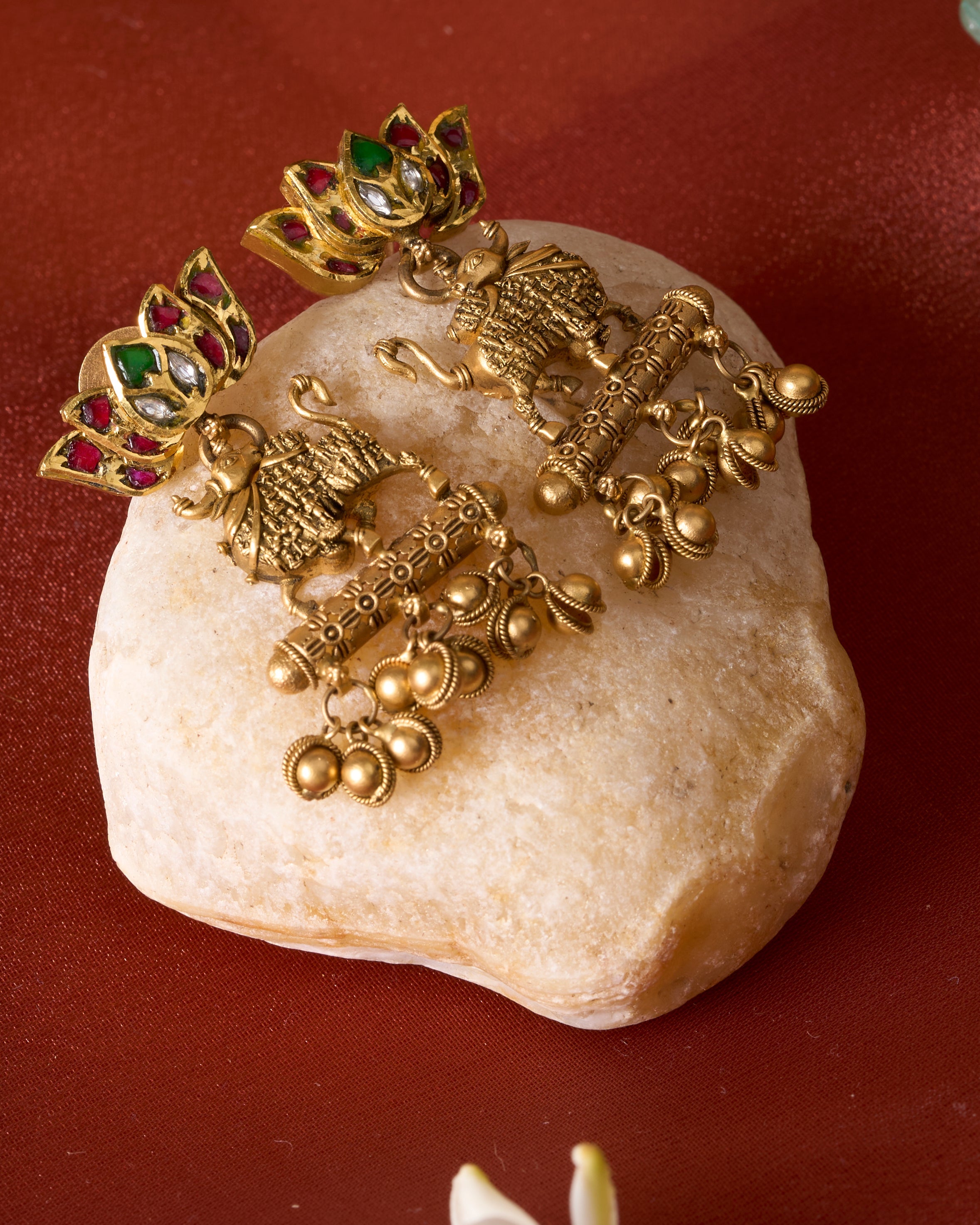Traditional gold Kamdhenu temple earrings with sacred cow motifs and gemstone accents