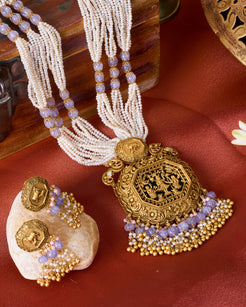 Traditional Kamdhenu temple jewelry set with multi-strand pearls and tanzanite beads in antique gold