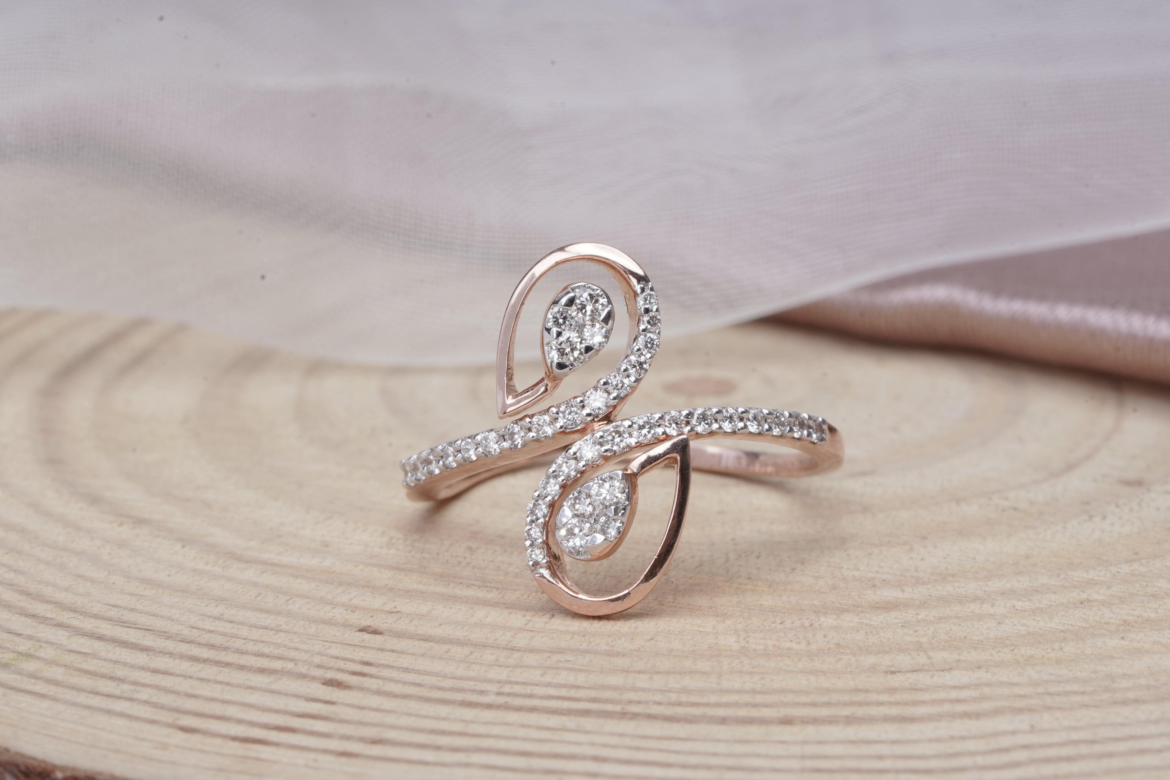 14K rose gold infinity-inspired ring with diamond pavé teardrop design 