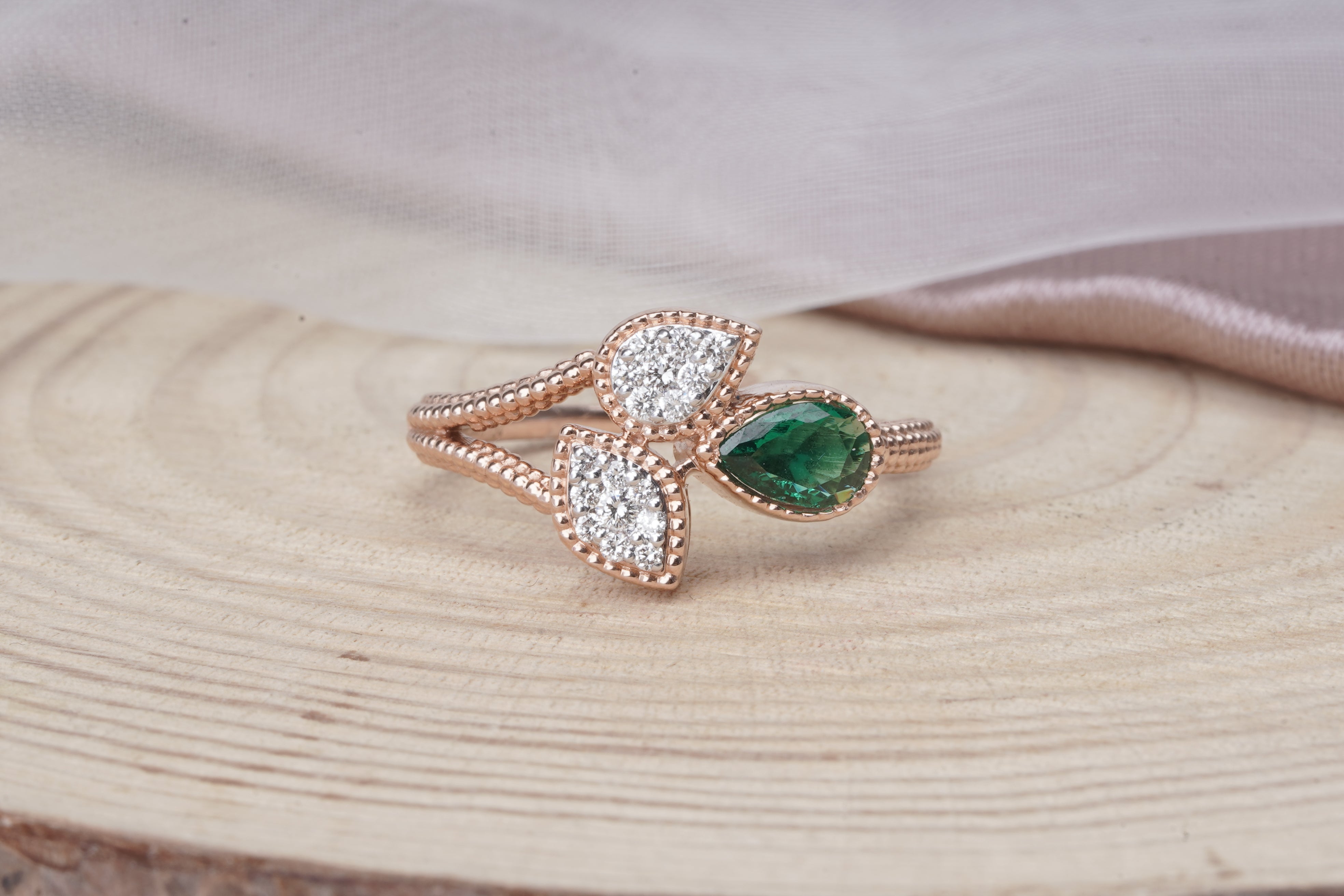  rose gold nature-inspired ring with emerald and diamond leaf design 