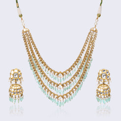 Three-tiered polki necklace set with mint green drops and matching jhumka earrings