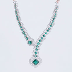 Contemporary necklace set with geometric emerald and diamond patterns, crafted in 14K gold.