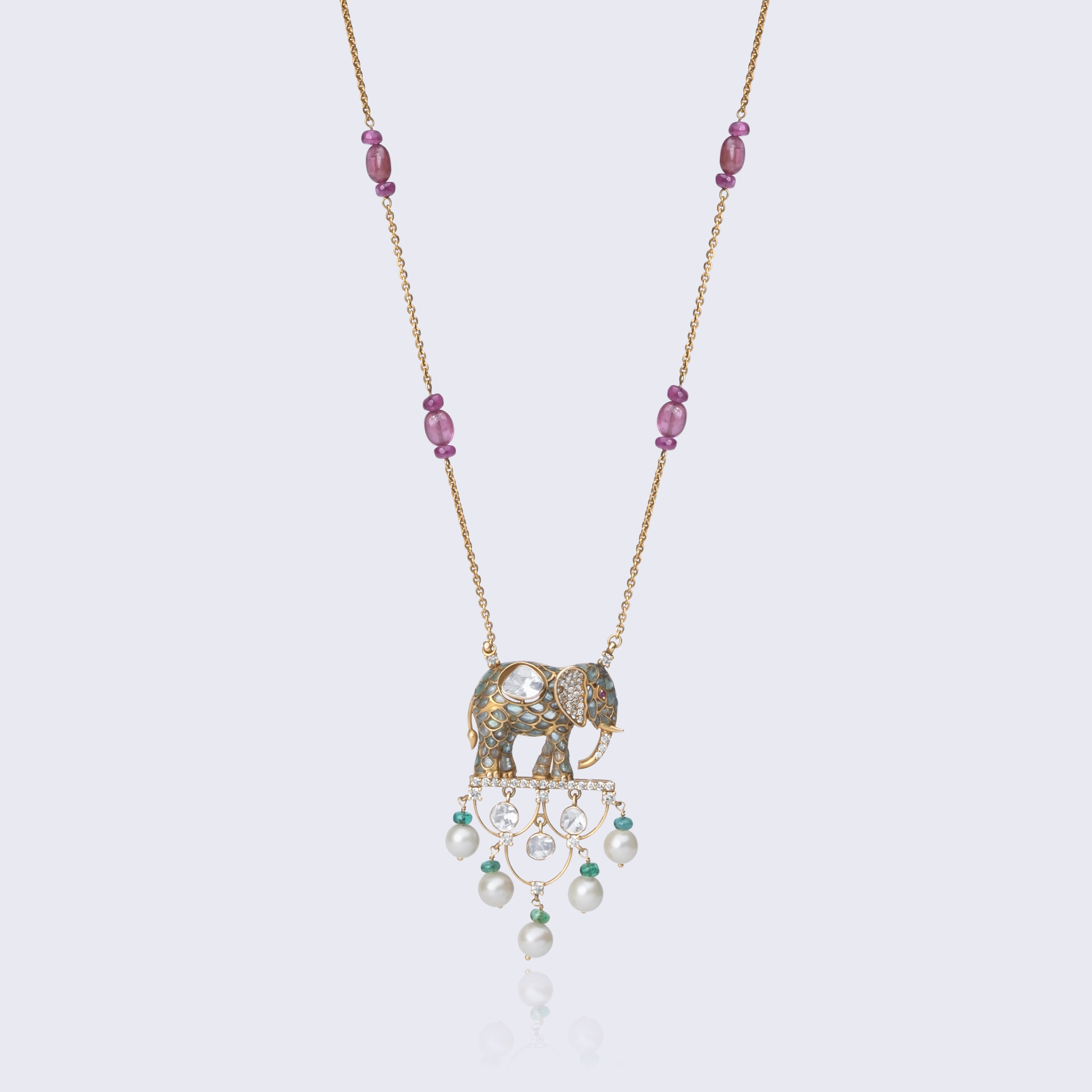 Traditional 14K gold elephant polki pendant with pearl drops, ruby and emerald beads, featuring intricate Indian craftsmanship