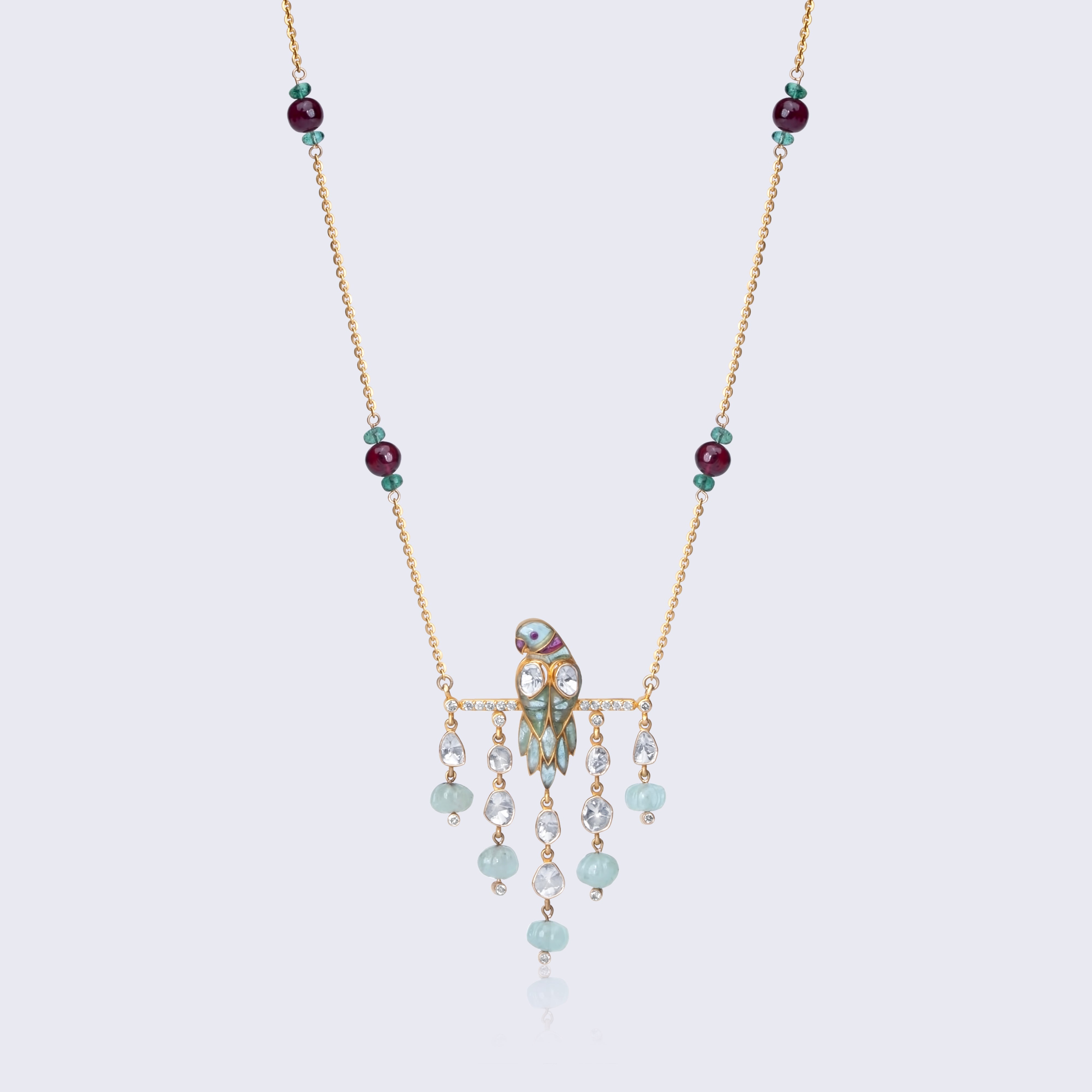Traditional 14K gold polki pendant with ruby and emerald gemstones featuring cascading beads and intricate craftsmanship