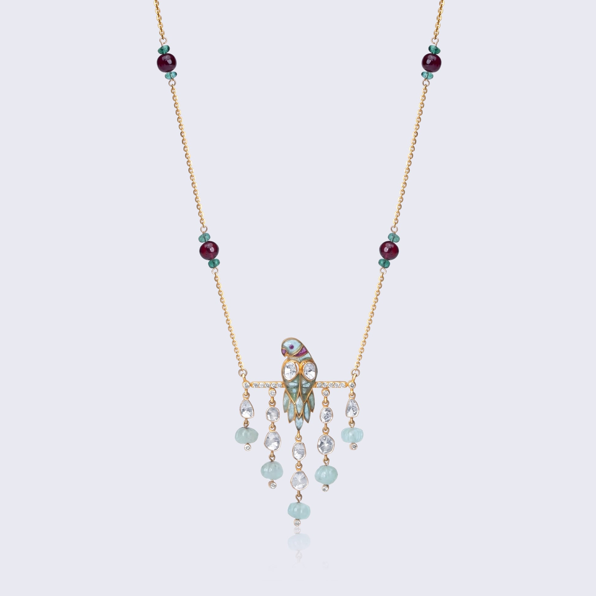 Traditional 14K gold polki pendant with ruby and emerald gemstones featuring cascading beads and intricate craftsmanship