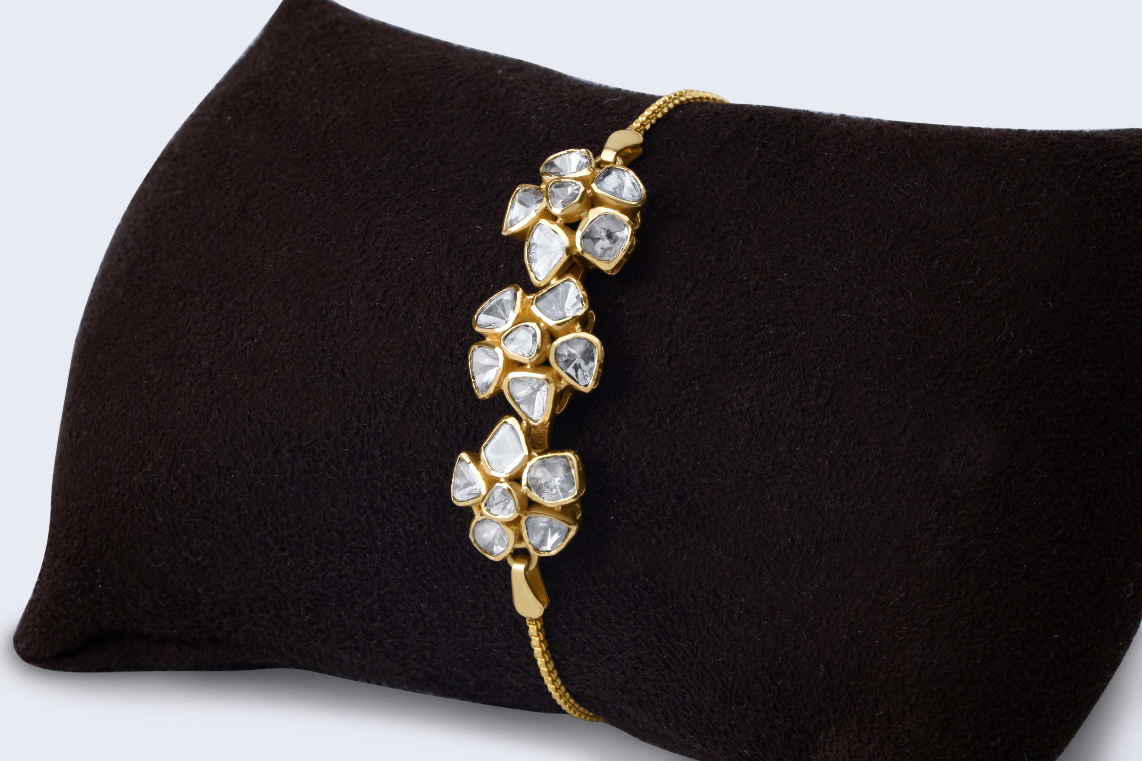 Elegant 14K gold polki floral cluster bracelet with three flower motifs featuring rose-cut polki diamonds and traditional Indian craftsmanship